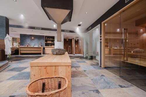 a large room with a counter in a store at Hotel Li Anta Rossa - Adults Only in Livigno