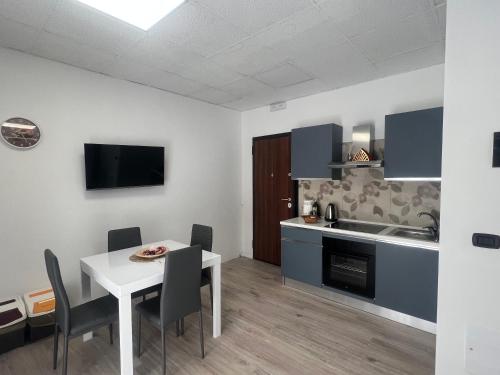 a kitchen and dining room with a white table and chairs at Lungotevere Testaccio 6 Roma - Apartments in Rome