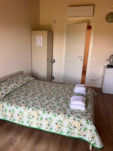 a bedroom with a bed with towels on it at Vigna di pettineo - guest house in Vittoria
