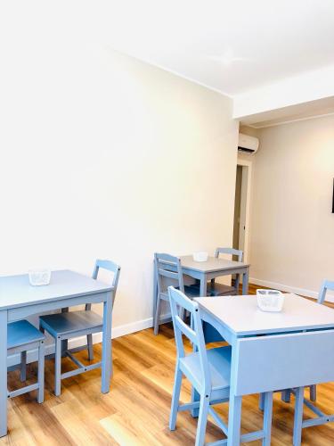 a dining room with blue tables and chairs at Il Giardinetto - Guest Room Policlinico in Messina