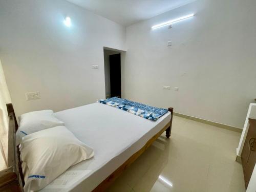 a small bedroom with a bed in a room at Weekly Stays in Manipal in Manipala