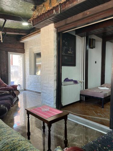 a living room with a table in the middle of a room at Top House in Šabac
