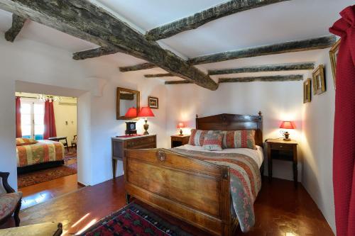 a bedroom with a bed and two tables and two lamps at Le Hameau in Saint-Paul-de-Vence