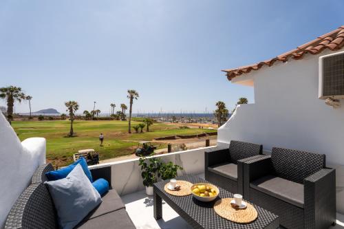 a patio with a table and chairs on a balcony at The Skippers Nest in San Miguel de Abona