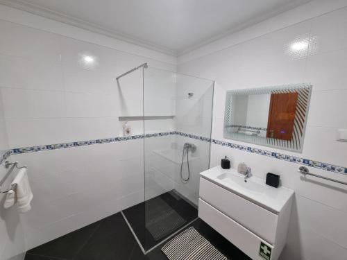a white bathroom with a sink and a shower at Julianas Place by Susys Holidays in Funchal