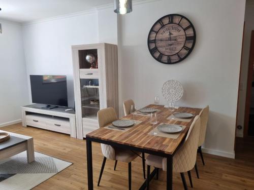 a dining room with a table and a clock on the wall at Julianas Place by Susys Holidays in Funchal