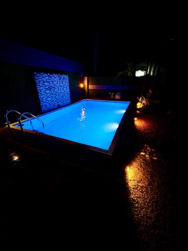 a large swimming pool in a dark room with lights at Shehan Villa in Beruwala
