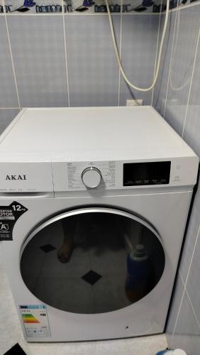 a washing machine with a white top in a room at Nata haus in Kvariati