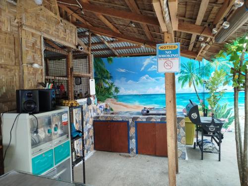 a kitchen with a view of the beach at La'Cris Homestay in Ocoy