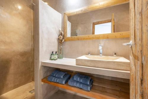 a bathroom with a sink and a mirror at Villa Dassos by Villa Plus in Skinária