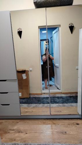 a woman taking a picture in a mirror at Nata haus in Kvariati