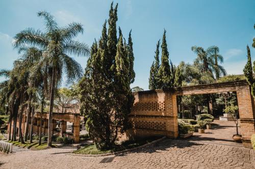 a courtyard with trees and a brick building at Haras Buona Fortuna in Cotia