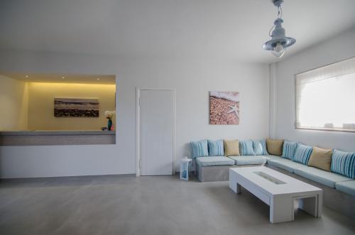 a living room with a couch and a table at Brother's Hotel in Ios Chora