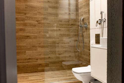 a bathroom with a toilet and a shower at ZimaSnow Ski & Spa Club in Bukovel
