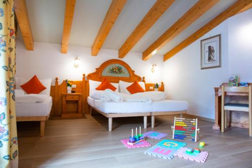 a bedroom with a bed and a table with toys at Hotel Bonapace ***S in Madonna di Campiglio