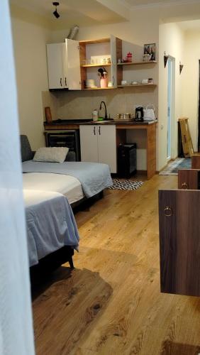 a living room with two beds and a kitchen at Nata haus in Kvariati