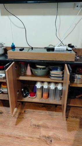 a wooden shelf with dishes and other items on it at Nata haus in Kvariati