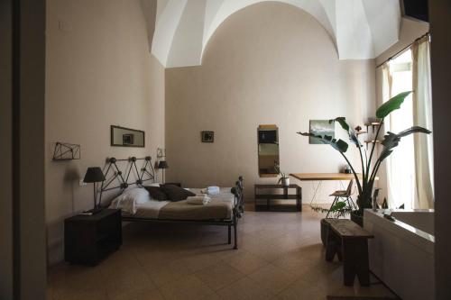 a bedroom with a bed and a large window at 4 Balconi rooms-Boutique B&B in Lecce