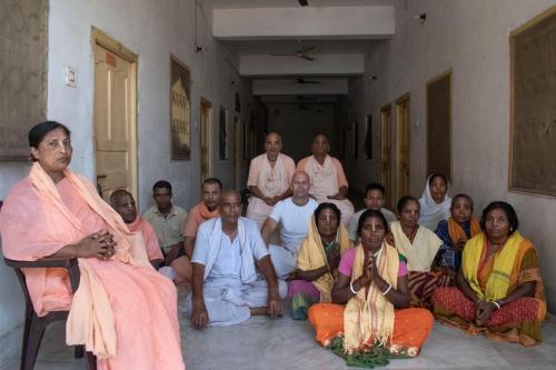 a group of people posing for a picture in a room at Sri Chaitanya Saraswat Math in Krishnanagar
