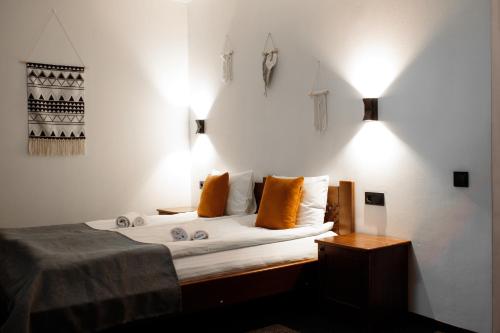 a bedroom with a bed with orange pillows at ZimaSnow Ski & Spa Club in Bukovel