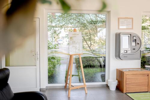 a glass door with a sign in front of it at Hotel Donau-Ries in Mertingen