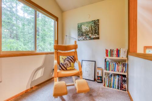 a room with a chair and a book shelf at The Burrow at Zig Zag in Rhododendron