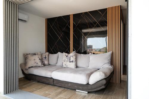 a living room with a couch with pillows on it at Four Points in Vir