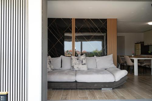 a living room with a white couch with pillows at Four Points in Vir
