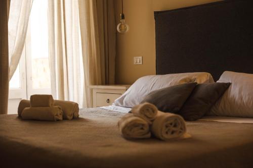 a bedroom with two beds with towels on them at 4 Balconi rooms-Boutique B&B in Lecce