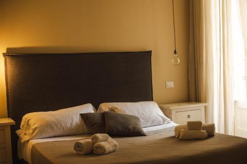 a bedroom with a bed with two stuffed animals on it at 4 Balconi rooms-Boutique B&B in Lecce
