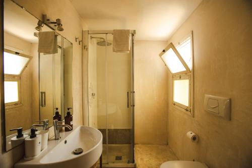 a bathroom with a sink and a shower and a toilet at 4 Balconi rooms-Boutique B&B in Lecce