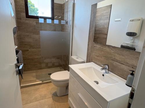 a bathroom with a sink and a toilet at GuestHouse Le Patio34 in Lavérune