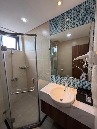 a bathroom with a sink and a shower at Sun View Homestay in Ha Long
