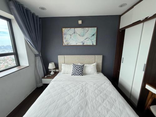 a bedroom with a bed and a painting on the wall at Sun View Homestay in Ha Long