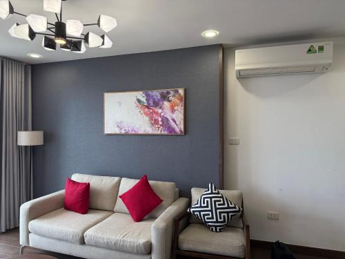 a living room with a couch and a painting at Sun View Homestay in Ha Long