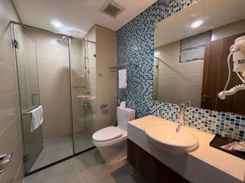 a bathroom with a shower and a toilet and a sink at Sun View Homestay in Ha Long