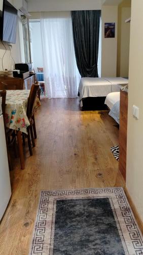 a room with a bedroom with a bed and a table at Nata haus in Kvariati