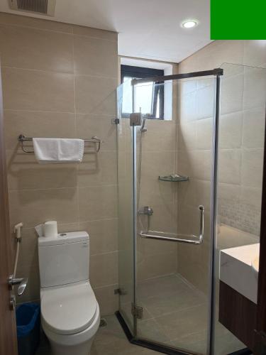 a bathroom with a toilet and a glass shower at Sun View Homestay in Ha Long