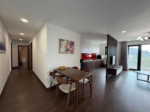 a kitchen and dining room with a table and chairs at Sun View Homestay in Ha Long