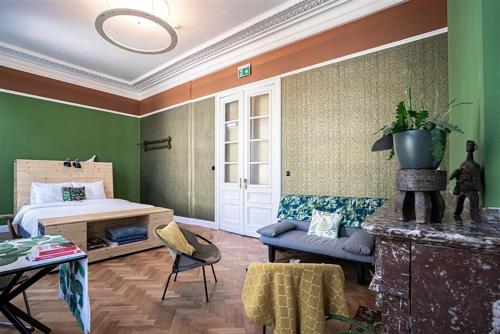 a bedroom with a bed and a couch and a table at 22b&b in Antwerp