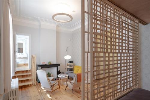 a living room with a large glass door with chairs and a fireplace at 22b&b in Antwerp