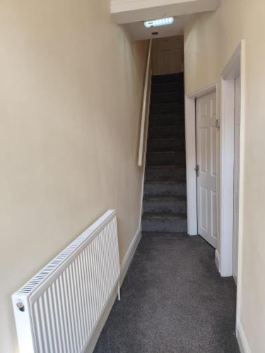 a hallway with stairs and a stair case at En-Suite Double-Bedroom in the Heart of Salford Manchester CR1 Perfect for Short Stays in Manchester