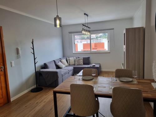a living room with a table and a couch at Julianas Place by Susys Holidays in Funchal