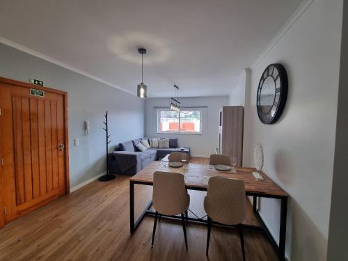 a dining room and living room with a table and chairs at Julianas Place by Susys Holidays in Funchal