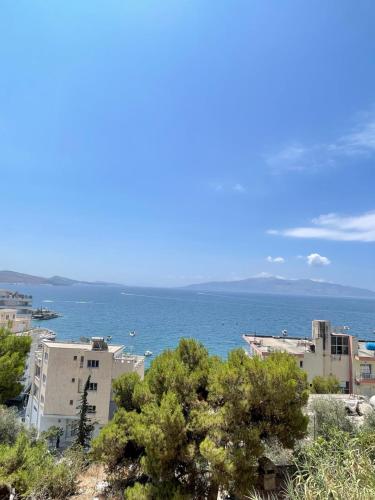 a view of the ocean from a city at Saranda Apartment in Polisi i Vogël
