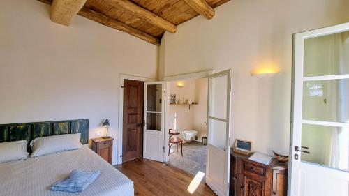 a bedroom with a bed and a door to a bathroom at Bed and Breakfast Via Rinaldi in Madonna del Sasso