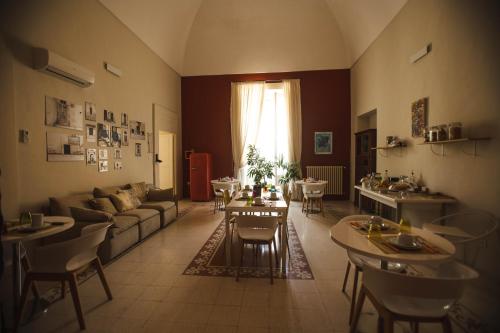 a living room with a couch and a table and chairs at 4 Balconi rooms-Boutique B&B in Lecce