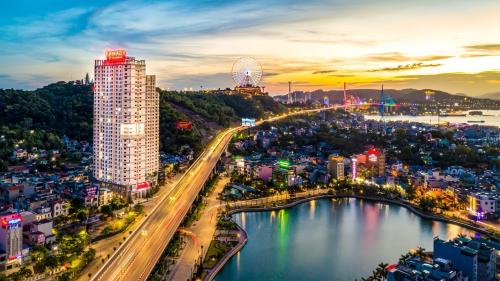 a city with a bridge over a body of water at Sun View Homestay in Ha Long
