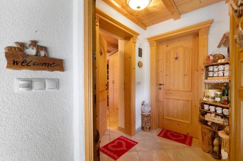 a hallway with a welcome sign on the wall at Untertalhof in Castelrotto
