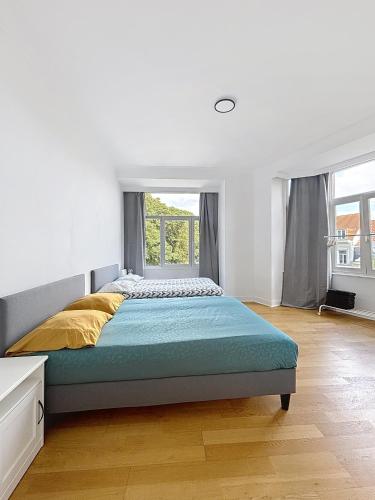 a bedroom with a large bed and a window at City Brussels 5 in Brussels